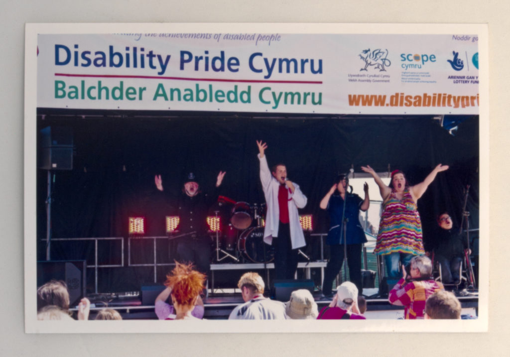 Performers with disabilities celebrating on stage at a Disability Pride festival